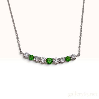 Sale Photo Thumbnail #217: A Platinum Demantoid Garnet and Diamond Curved Bar Necklace