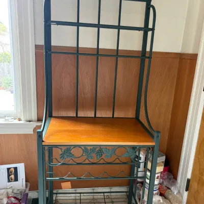 Sale Photo Thumbnail #36: Wrought iron baker's rack with a wooden shelf, featuring decorative grape leaf motifs and a built-in wine rack.