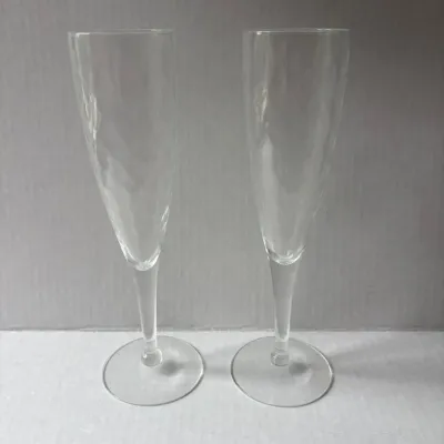 Sale Photo Thumbnail #29: Pair of elegant champagne flutes with a subtle optic swirl pattern.