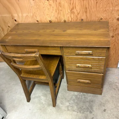 Sale Photo Thumbnail #17: Vintage student desk featuring a single lap drawer and three side drawers with wooden pulls, paired with a matching wooden chair.