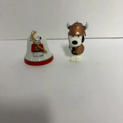 Sale Photo Thumbnail #6: Vintage Peanuts Snoopy ceramic Christmas ornaments, featuring a bell ornament with Snoopy on his doghouse and a Snoopy figure dressed as a Viking.