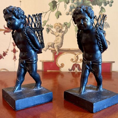A Pair of Patinated Cast Metal Neoclassical Putti Spill Holders
