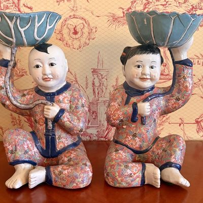 A pair of famille rose millefleur seated children offering stands-One With Repair