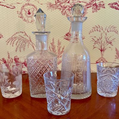 A Collection of Cut Crystal Decanters and Tumblers