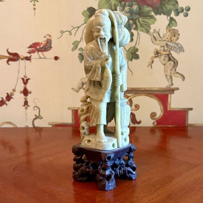 A carved soapstone figure of a fisherman, 20th century