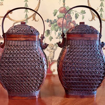 A pair of woven bamboo and red lacquer lidded baskets, 20th century