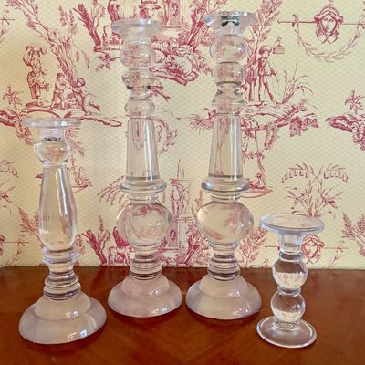 A Set of Four Graduated Clear Glass Candlesticks