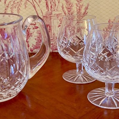 A Group of Cut Crystal Tableware Including Pitcher and Stemmed Brandy Glasses