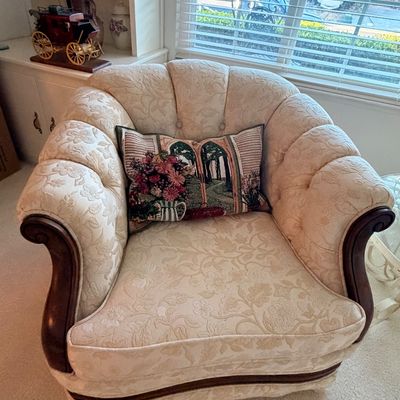 Sale Photo Thumbnail #21: Traditional tufted armchair with cream floral damask upholstery, curved wooden arm accents, and a matching tapestry throw pillow.