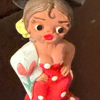 Sale Photo Thumbnail #119: Vintage painted clay flamenco dancer figurine wearing a black brimmed hat and a red polka-dot dress.