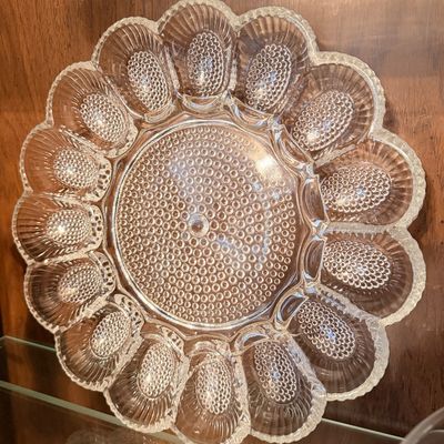 Sale Photo Thumbnail #111: Vintage clear pressed glass deviled egg platter featuring a hobnail and scalloped rim design with twelve egg wells.