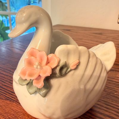 Sale Photo Thumbnail #87: Glazed ceramic swan planter adorned with applied pink porcelain flowers and green leaves.