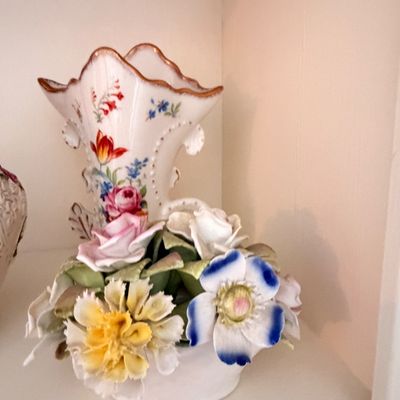 Sale Photo Thumbnail #12: Vintage porcelain floral vase featuring a hand-painted tulip design and a sculpted base adorned with three-dimensional ceramic flowers.