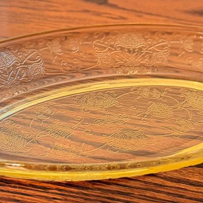 Sale Photo Thumbnail #66: Vintage yellow Depression glass oval serving dish featuring an intricate molded floral pattern.