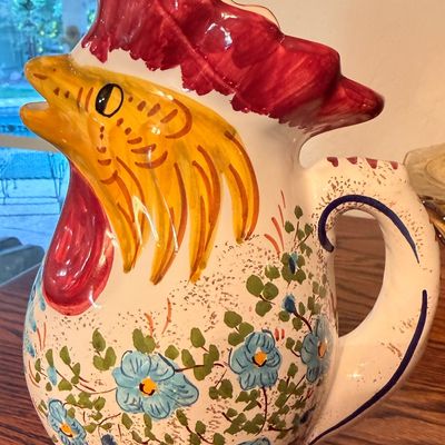Sale Photo Thumbnail #92: Hand-painted Italian ceramic rooster pitcher featuring vibrant floral details and a molded head spout.