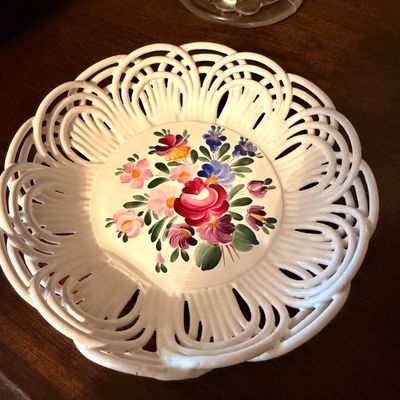 Sale Photo Thumbnail #114: Hand-painted ceramic reticulated basket dish featuring a colorful floral bouquet design on a white glazed finish.