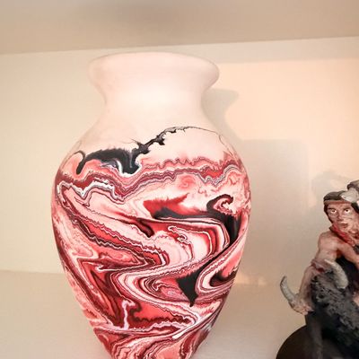 Sale Photo Thumbnail #25: Southwestern-style ceramic vase featuring a marbled red, black, and white glaze pattern on a cream-colored base.