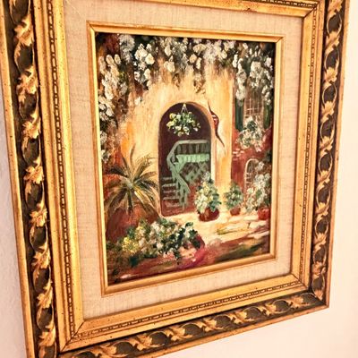 Sale Photo Thumbnail #37: Impressionistic oil painting depicting a courtyard scene with lush greenery and flowers, housed in an ornate, gilded wood frame with a linen liner.