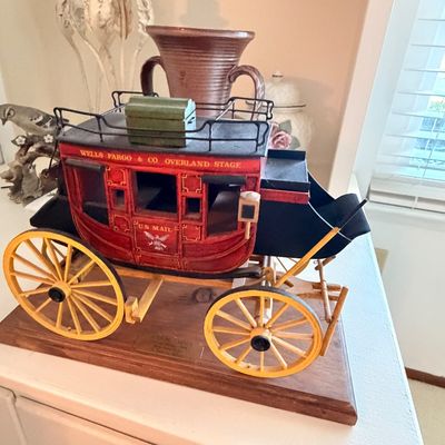 Sale Photo Thumbnail #22: Vintage wooden model of a Wells Fargo & Co. Overland Stagecoach, mounted on a wooden display base.