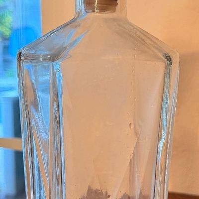 Sale Photo Thumbnail #71: Mid-century vintage clear glass decanter featuring geometric faceted sides and a matching glass topper with a cork neck insert.