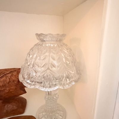 Sale Photo Thumbnail #13: Vintage pressed clear glass fairy lamp featuring a dome shade with a leaf pattern and a textured pedestal base.