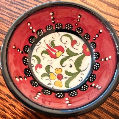 Sale Photo Thumbnail #103: Hand-painted Turkish style ceramic bowl featuring a red rim and floral central motif.