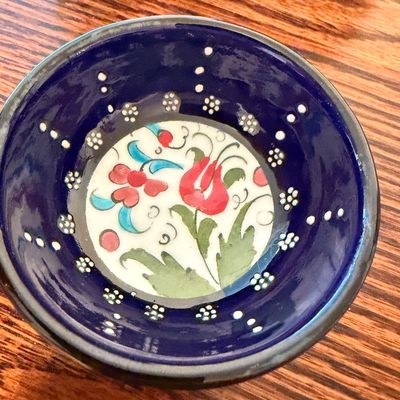 Sale Photo Thumbnail #99: Hand-painted Turkish ceramic bowl featuring a vibrant cobalt blue interior with white raised dot accents and a floral center design.