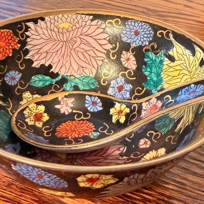 Sale Photo Thumbnail #105: Vintage Chinese Famille Noire porcelain bowl and matching soup spoon featuring intricate hand-painted floral motifs and gold accents.