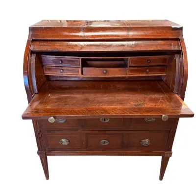 Sale Photo Thumbnail #48: Antique mahogany cylinder roll-top desk featuring a pull-out writing surface, interior cubbies and drawers, and two lower drawers with brass hardware.