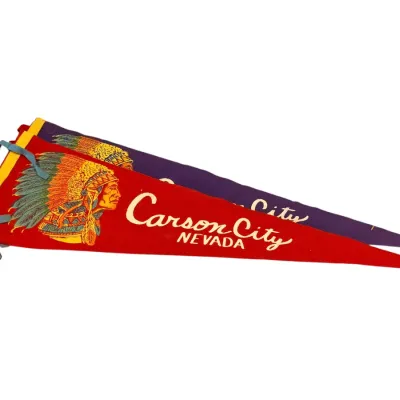 Sale Photo Thumbnail #16: Two vintage felt souvenir pennants for Carson City, Nevada, featuring a colorful Native American chief graphic, circa mid-20th century.
