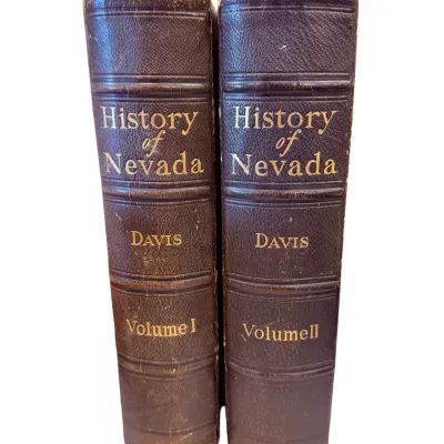 Sale Photo Thumbnail #21: Two-volume set of "History of Nevada" by Sam P. Davis, published in 1913, featuring brown leather bindings with gilt lettering on the spines.