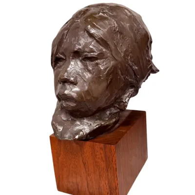 Sale Photo Thumbnail #51: Bronze bust sculpture depicting a Native American child, featuring a textured, impressionistic finish and mounted on a square wooden block base.
