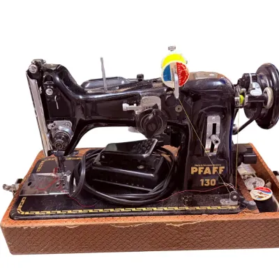 Sale Photo Thumbnail #56: Vintage Pfaff 130 sewing machine in a textured brown carrying case base, complete with foot pedal and thread spools.