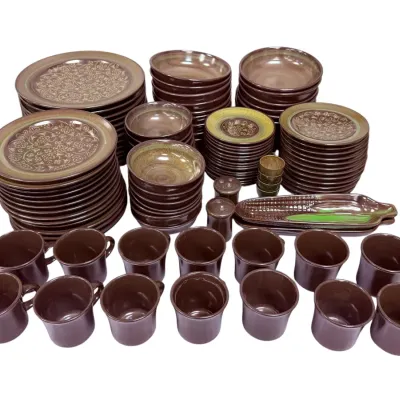 Sale Photo Thumbnail #39: Vintage Pfaltzgraff "Heritage Brown" or similar stoneware dinnerware set, including dinner plates, salad plates, bowls, mugs, and serving pieces with a glossy brown glaze and embossed floral details.