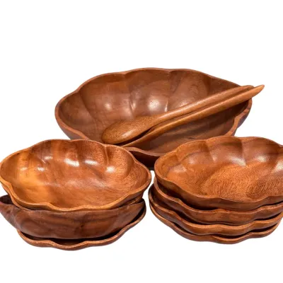 Sale Photo Thumbnail #31: Vintage monkey pod wood salad set featuring a large scalloped serving bowl with matching serving utensils and individual salad bowls.