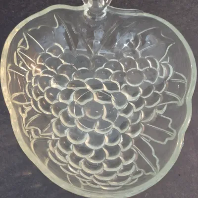 Vintage Indiana Glass clear pressed glass serving dish shaped like a bunch of grapes with a stem handle.