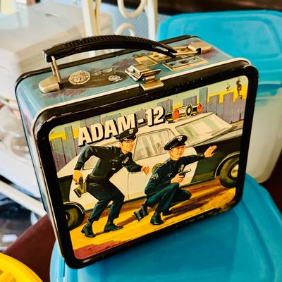 Sale Photo Thumbnail #3: Vintage 1972 Aladdin Adam-12 metal lunchbox, featuring graphics of the classic television show with some minor wear along the edges.