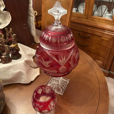 Sale Photo Thumbnail #61: Vintage Bohemian ruby cut-to-clear glass lidded candy dish with a matching small goblet, featuring etched wildlife and floral motifs.