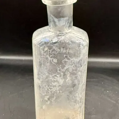 Antique Clear Glass Apothecary Bottle with Embossed Panel, Rainbow Iridescent Patina, Flared Lip