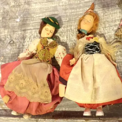 Sale Photo Thumbnail #55: Pair of vintage mid-century European souvenir dolls, likely Italian Lenci or similar style, dressed in traditional folk costumes with detailed embroidery and lace aprons.