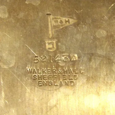Sale Photo Thumbnail #21: Walker & Hall Sheffield England manufacturer's mark stamped on a brass or silver-plated surface, featuring the brand's signature pennant flag logo and serial number 52143.