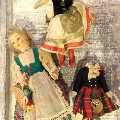 Sale Photo Thumbnail #56: Trio of vintage mid-century souvenir dolls in traditional European folk costumes, including two blonde dolls in regional dress and one headless doll in a Scottish tartan kilt.