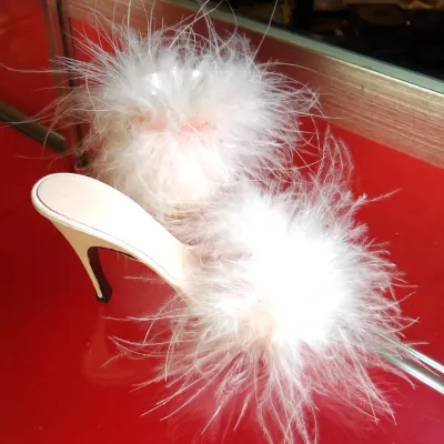 Sale Photo Thumbnail #25: Vintage Frederick's of Hollywood boudoir slippers featuring a high stiletto heel and fluffy white marabou feather trim.