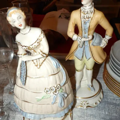 Sale Photo Thumbnail #54: Pair of vintage porcelain figurines depicting a courtly lady and gentleman in 18th-century attire, featuring hand-painted details and gold gilt accents.