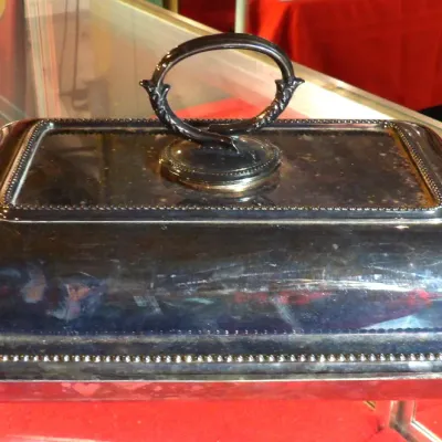 Sale Photo Thumbnail #20: Vintage silver-plated rectangular chafing dish lid featuring a beaded border and an ornate loop handle, showing some surface tarnish.