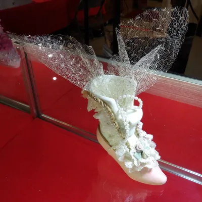 Sale Photo Thumbnail #37: Fenton-style decorative glass slipper, featuring elaborate lace trim, faux pearl accents, and a flared gold mesh insert.