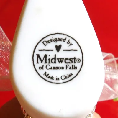 Sale Photo Thumbnail #28: Maker's mark on a white ceramic item, reading "Designed by Midwest of Cannon Falls, Made in China."