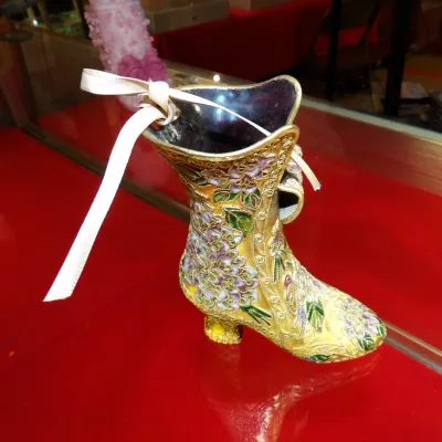 Sale Photo Thumbnail #35: Vintage cloisonné enamel high-heeled boot figurine, featuring intricate gold-tone filigree with purple and green floral motifs and a decorative ribbon accent.