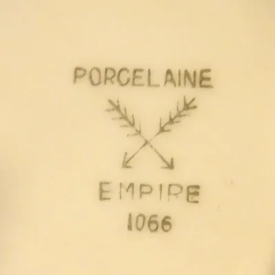 Sale Photo Thumbnail #45: Maker's mark on the underside of a porcelain piece, featuring the "Porcelaine Empire" stamp with crossed arrows and the number 1066.