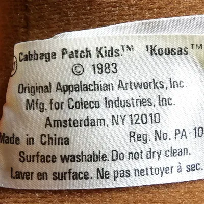 Sale Photo Thumbnail #9: Vintage 1983 Cabbage Patch Kids "Koosas" plush toy manufacturer tag, showing provenance from Original Appalachian Artworks, Inc. and manufactured for Coleco Industries, Inc.